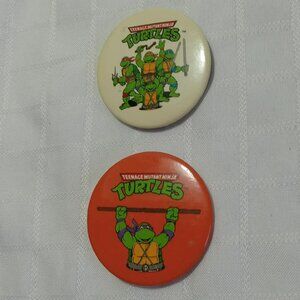 Two strange & unusual vintage button pins featuring The TNMT